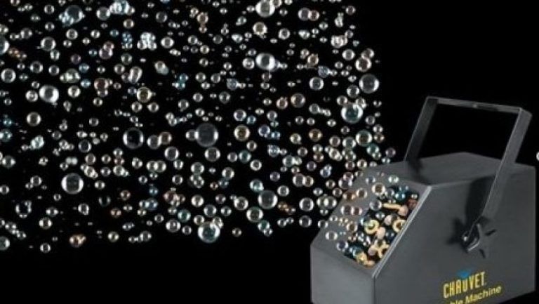 A machine that is making soap bubbles with a black background