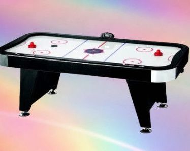 An air hockey table with a rainbow in the background