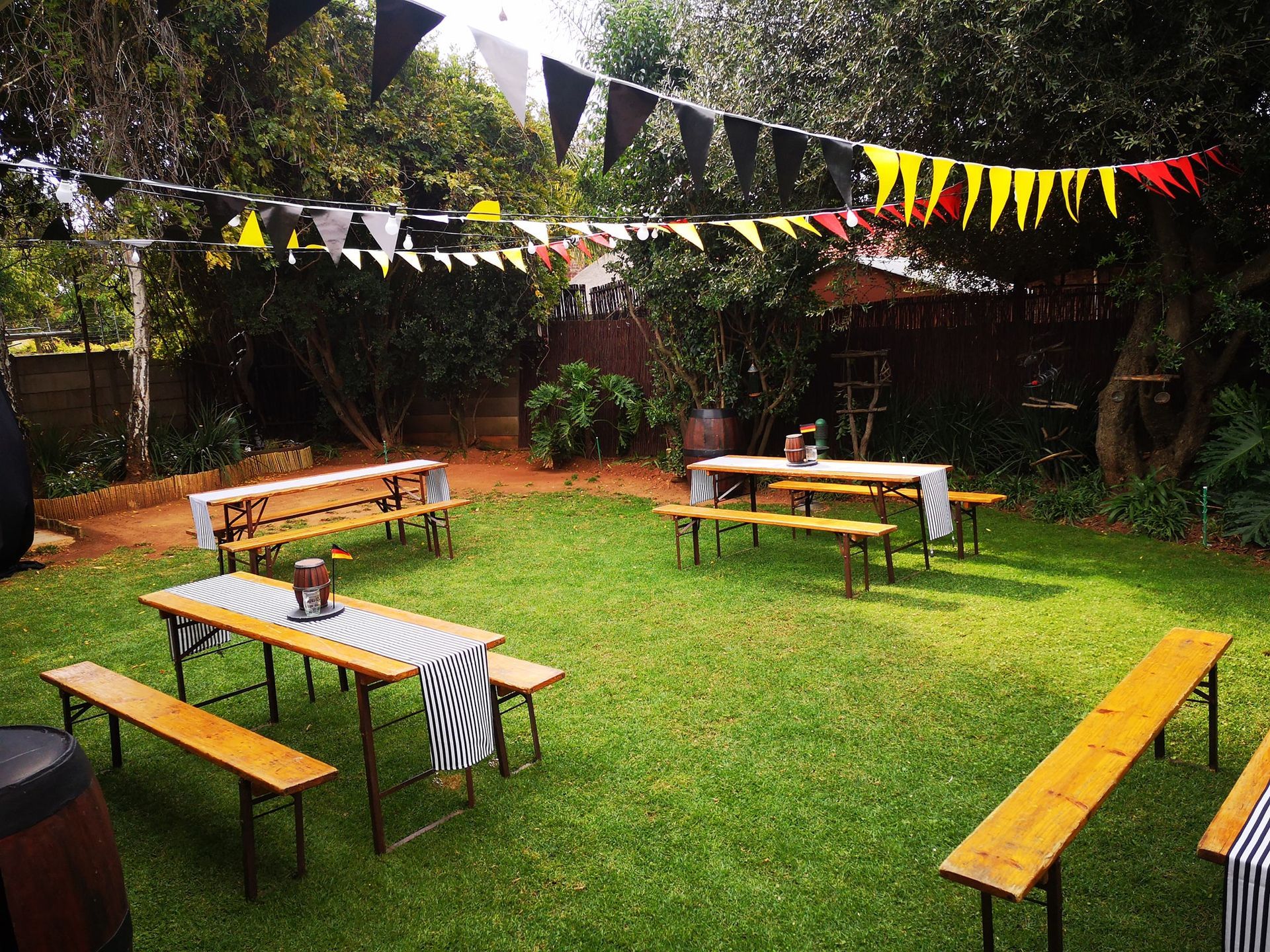 A bunch of tables and benches are sitting on top of a lush green field.