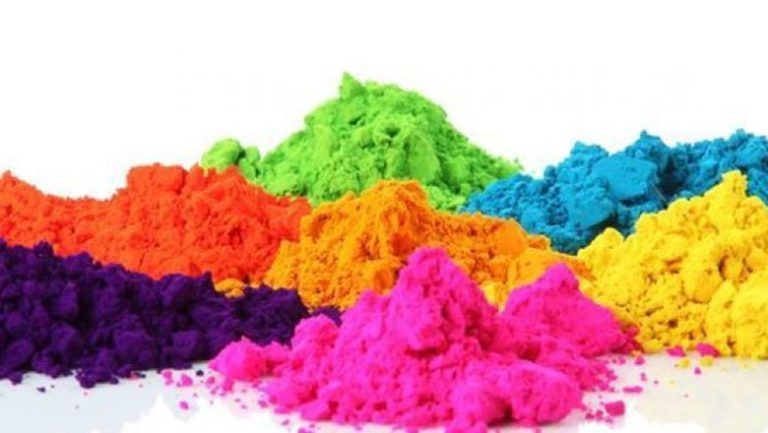 A pile of colorful powder on a white surface.