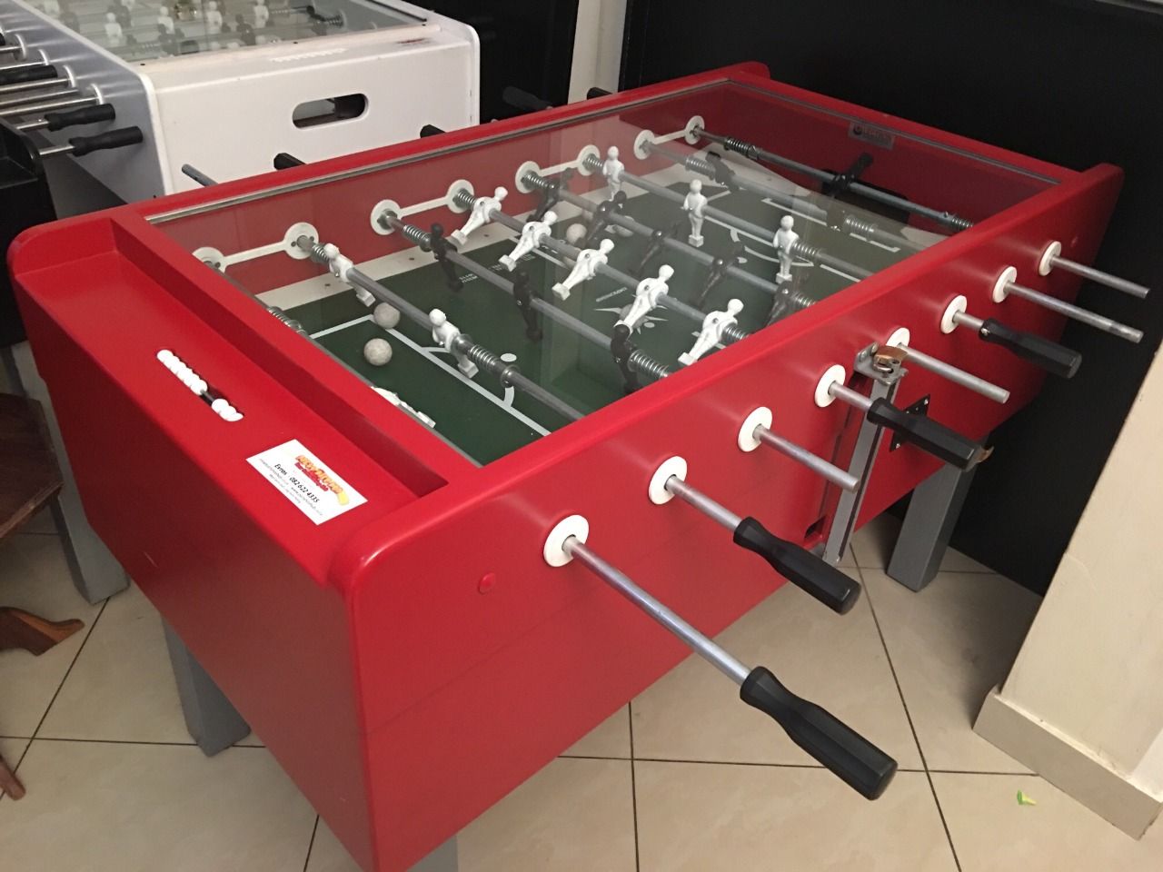 A red foosball table with a glass top