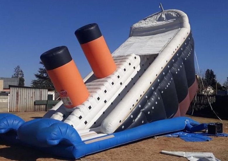 A large inflatable titanic ship is sitting on the ground
