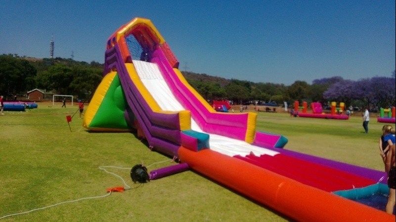 A large inflatable water slide is in the middle of a field.
