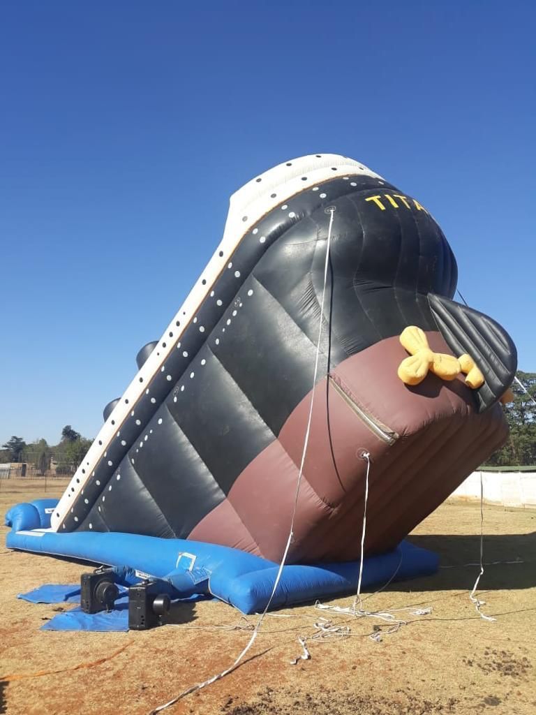 A large inflatable titanic ship is sitting on the ground