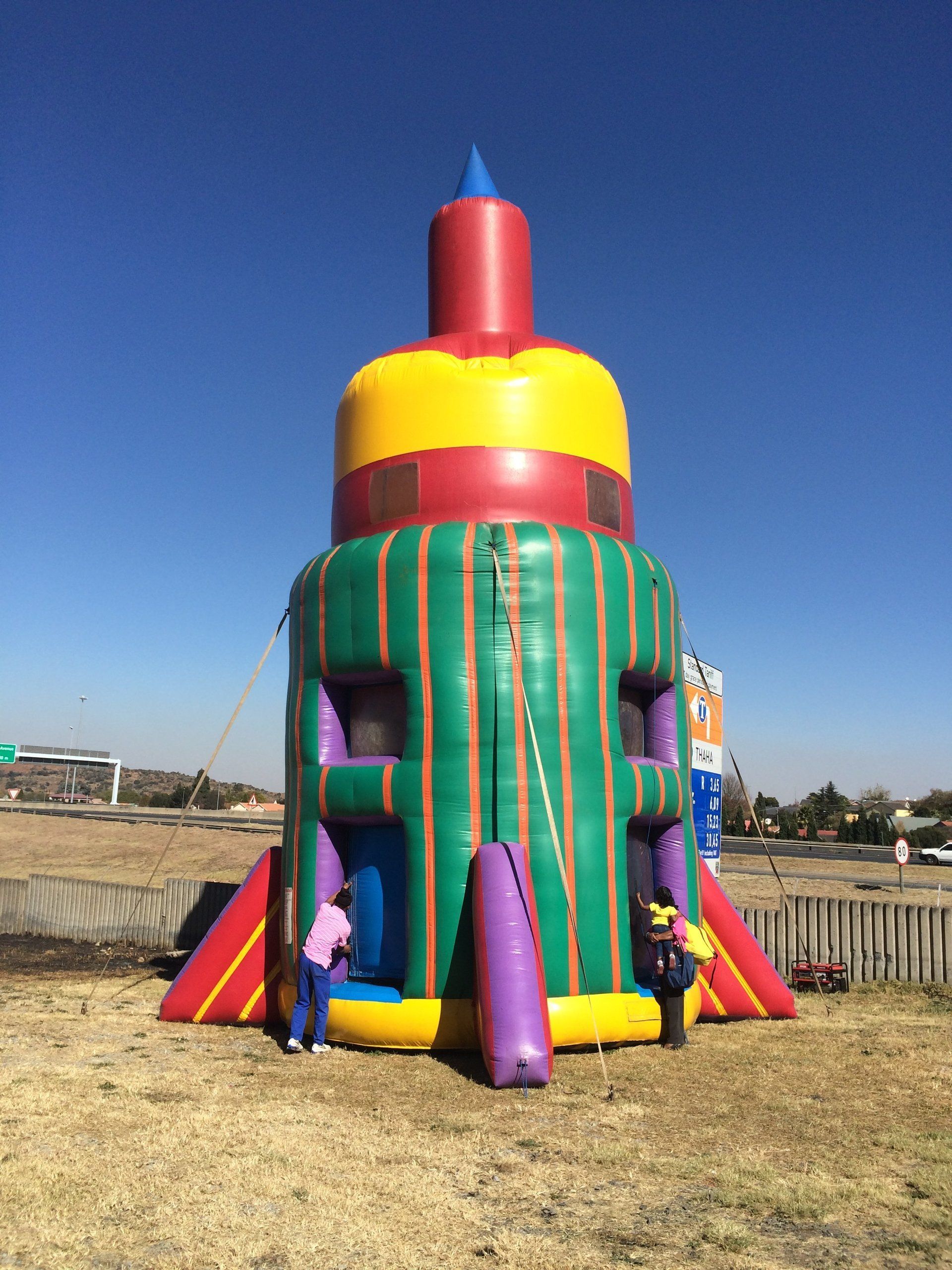 A colorful bouncy house in the shape of a rocket