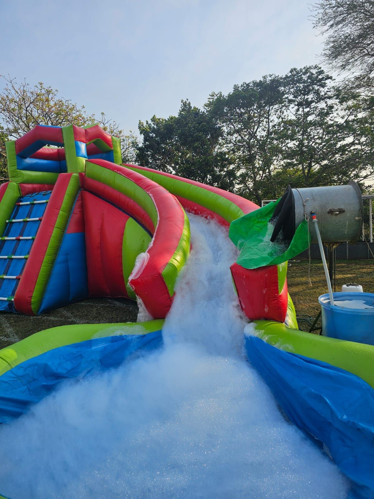 A large inflatable water slide with foam coming out of it.