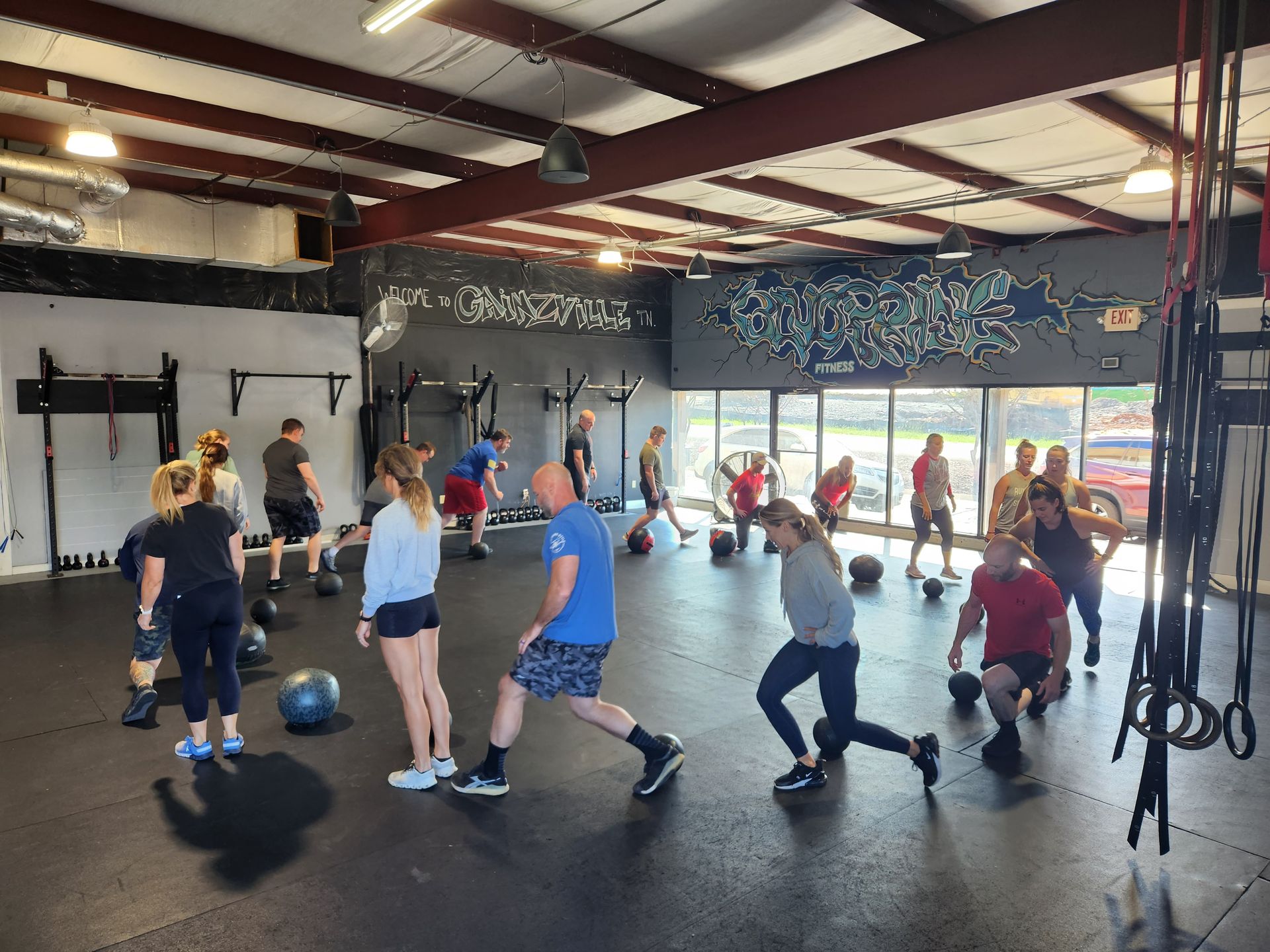 A group of people are doing exercises in a gym.