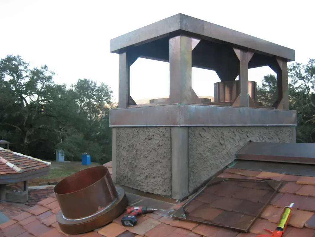 A Chimney on Top of A Roof with Tools on It | Santa Rosa, CA | Morris Heating and Sheet Metal