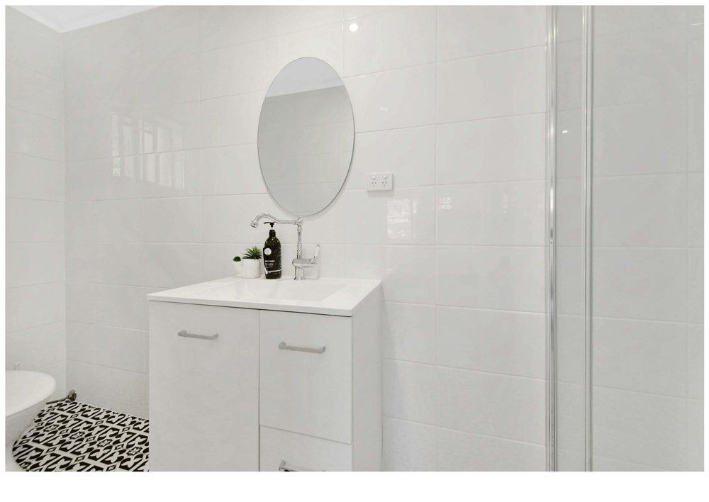 Bathroom With Mirror And Cabinet — Jones Building Group In Inverness, QLD