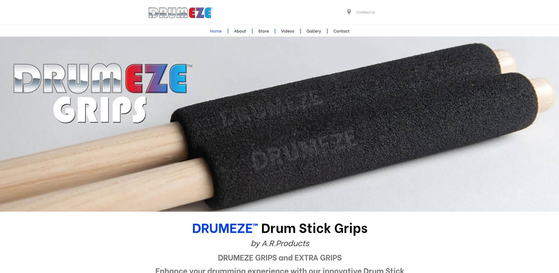 A pair of drumsticks with a black grip on them