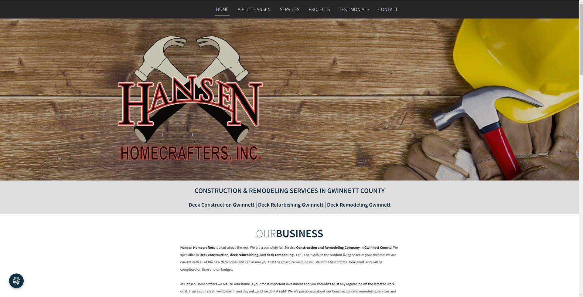 A website for hansen homecrafts inc. shows a hard hat and hammer on a wooden table.