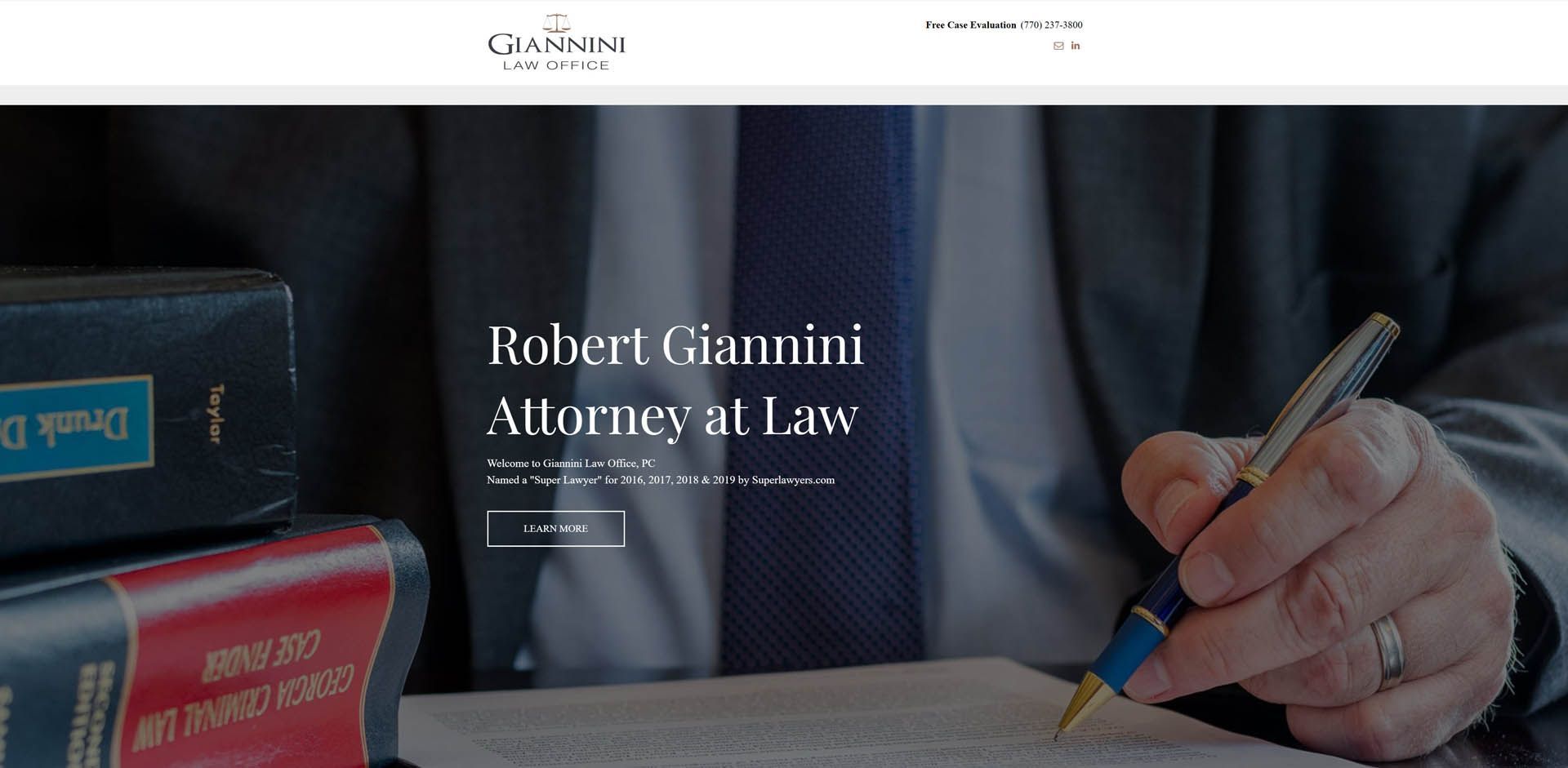 A man in a suit and tie is writing on a piece of paper with a pen.