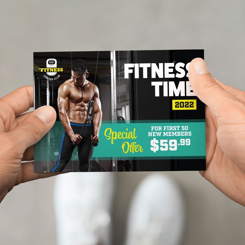 A person is holding a fitness time card in their hand.