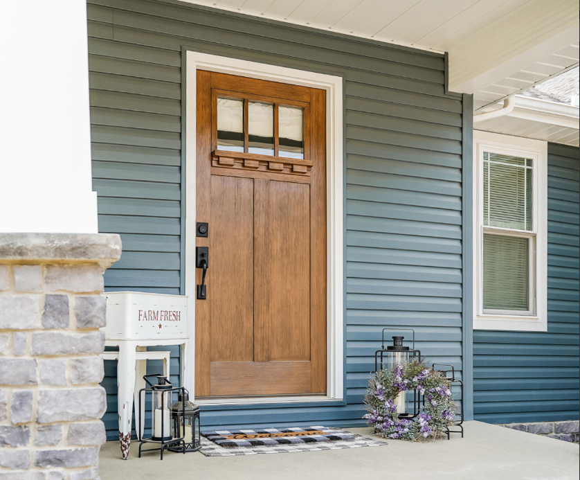 The front door of a house with stairs leading up to it
