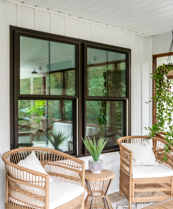 Three windows on the side of a house with green trim