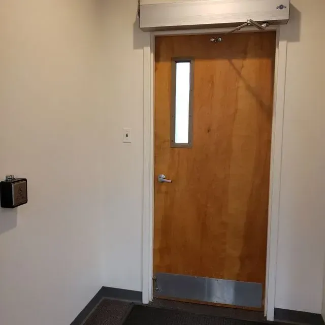 A wooden door with a small window in it