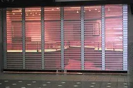 A store front with a roller shutter door that is closed.
