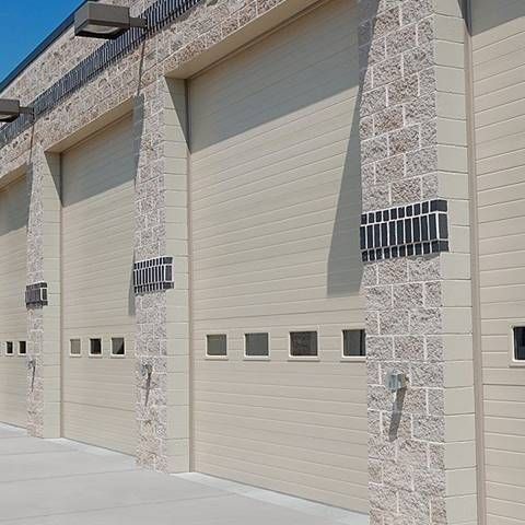 A row of garage doors on the side of a building.