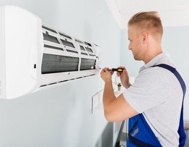HVAC Maintenance — Repairman Fixing Air Conditioner in Port Lavaca, TX