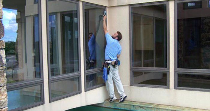 Man Cleaning Big Window — Monterey, CA — Better View Window Cleaners
