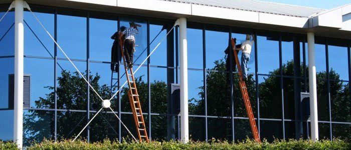 Two Workers Cleaning a Building Window — Monterey, CA — Better View Window Cleaners