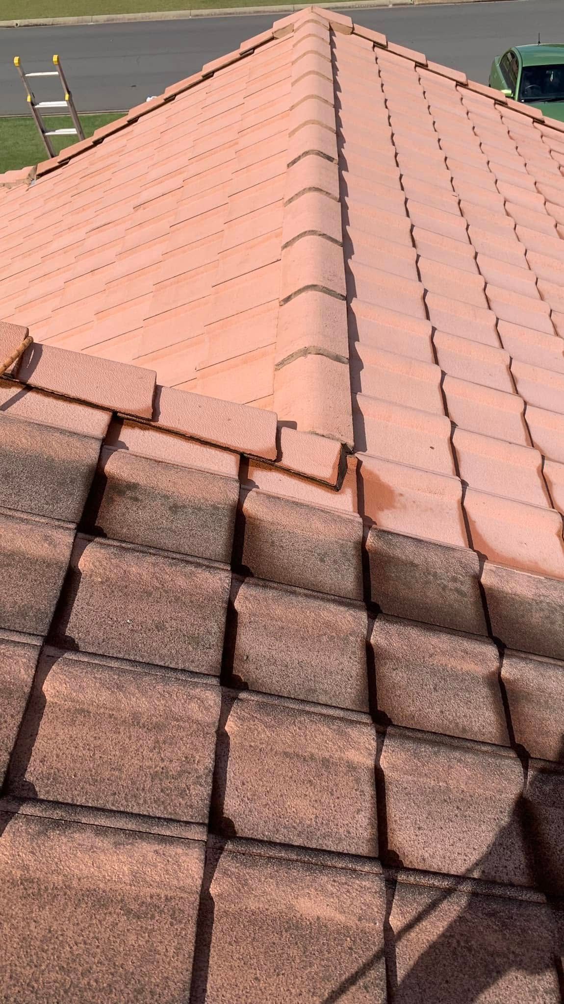 High-angle view of a roof with two sections of terracotta-colored concrete tiles and a central ridge cap. — CPR Exterior Cleaning in Bundaberg East, QLD