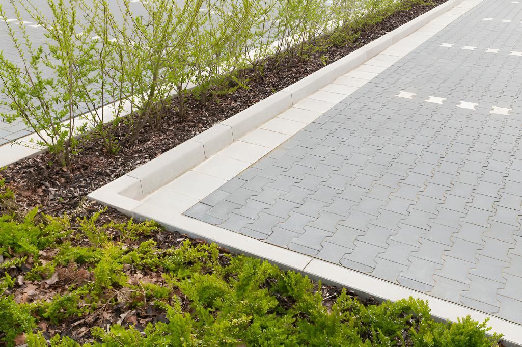 Close Up of a Parking Lot With a Curb and Plants — CPR Exterior Cleaning in Bargara, QLD