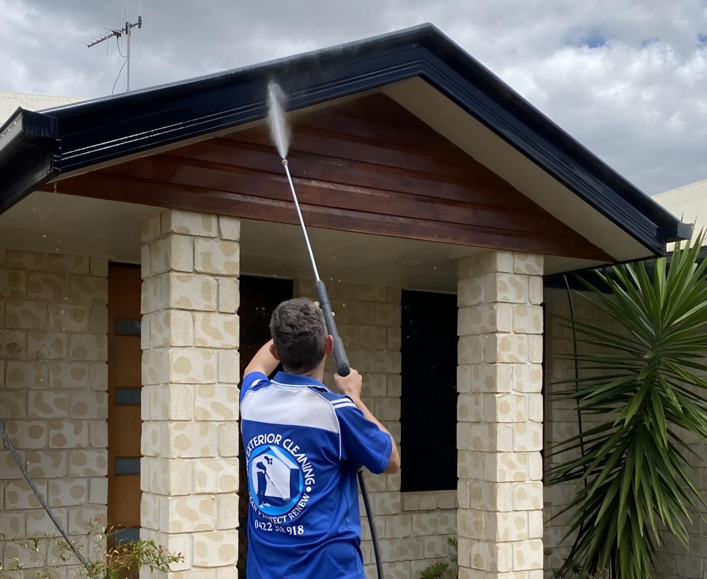 Man in a Blue Shirt is Cleaning a House — CPR Exterior Cleaning in Burnett Heads, QLD