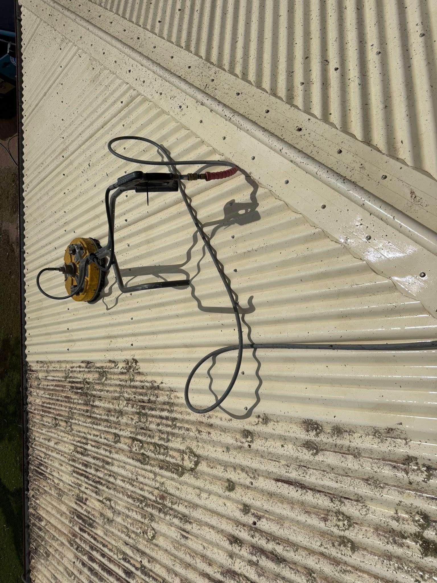 A Yellow Pressure Washer Surface Cleaner Sits on a Grimy — CPR Exterior Cleaning in Bundaberg East, QLD