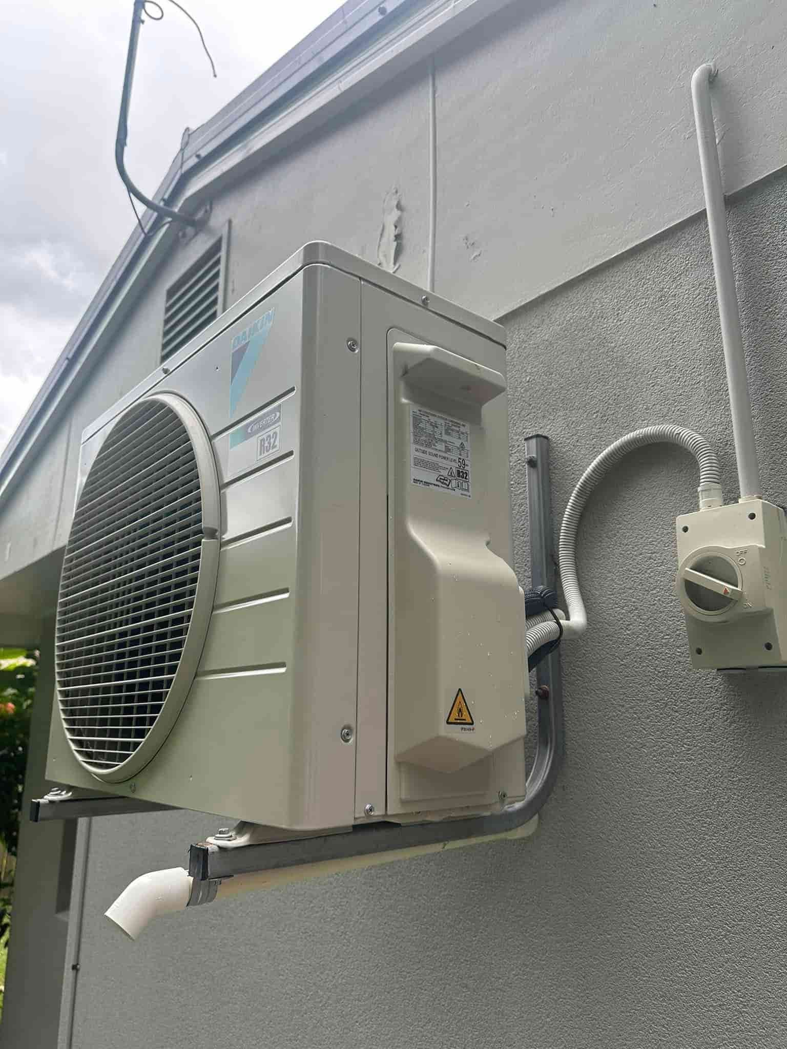 Air Conditioning Unit Mounted on a Grey Wall — Eclipse Air Conditioning and Refrigeration in Trinity Beach, QLD