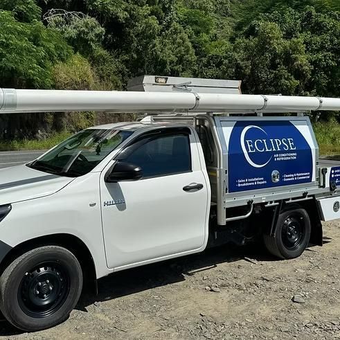 A White Truck is Parked on the Side of the Road — Eclipse Air Conditioning and Refrigeration in Trinity Beach, QLD