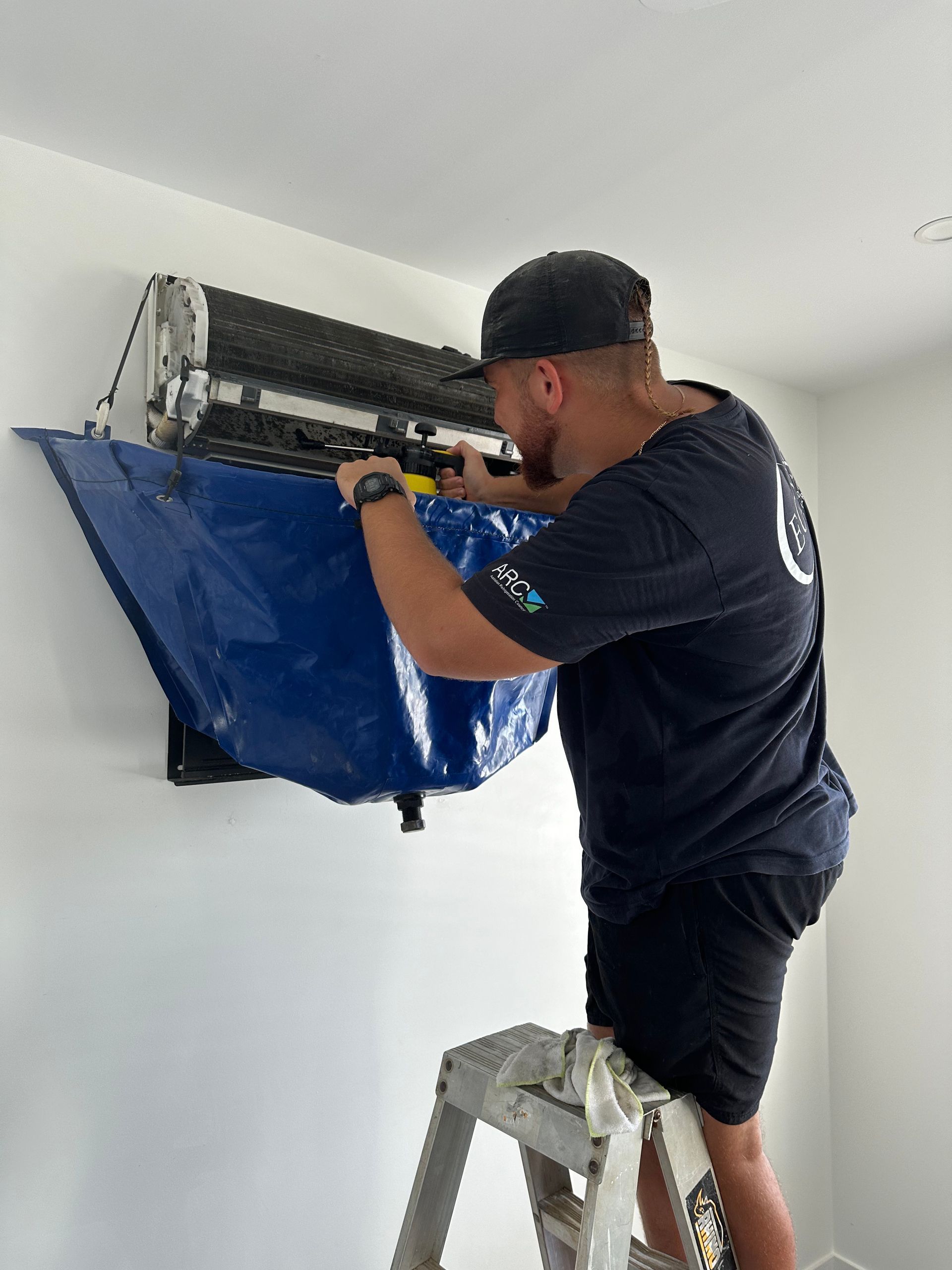 Man Cleaning a Air Con System — Eclipse Air Conditioning and Refrigeration in Trinity Beach, QLD