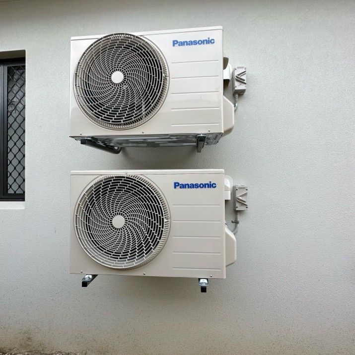 Two Panasonic Air Conditioners Mounted on a White Wall — Eclipse Air Conditioning and Refrigeration In Palm Cove, QLD