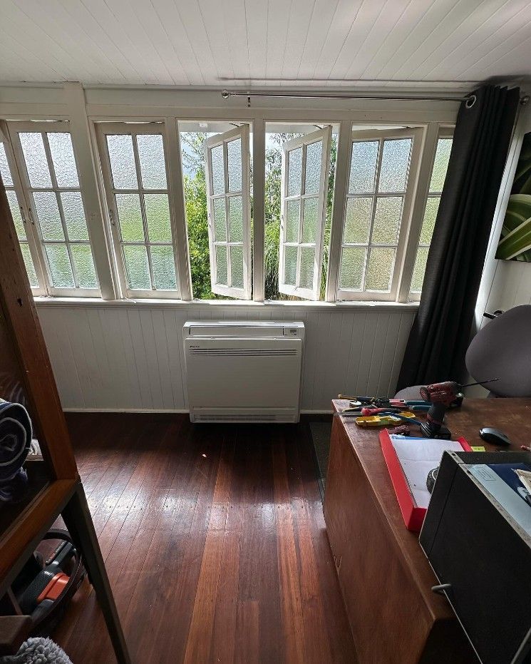 A Room With a Lot of Windows and a Heater in the Middle of the Room — Eclipse Air Conditioning and Refrigeration In Redlynch, QLD