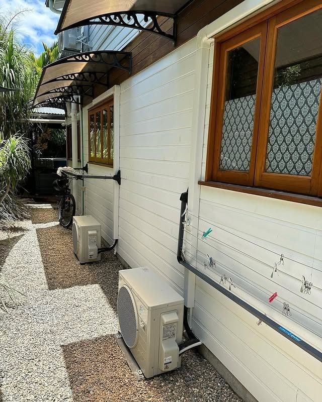 A Row of Air Conditioners on the Side of a Building — Eclipse Air Conditioning and Refrigeration In Redlynch, QLD