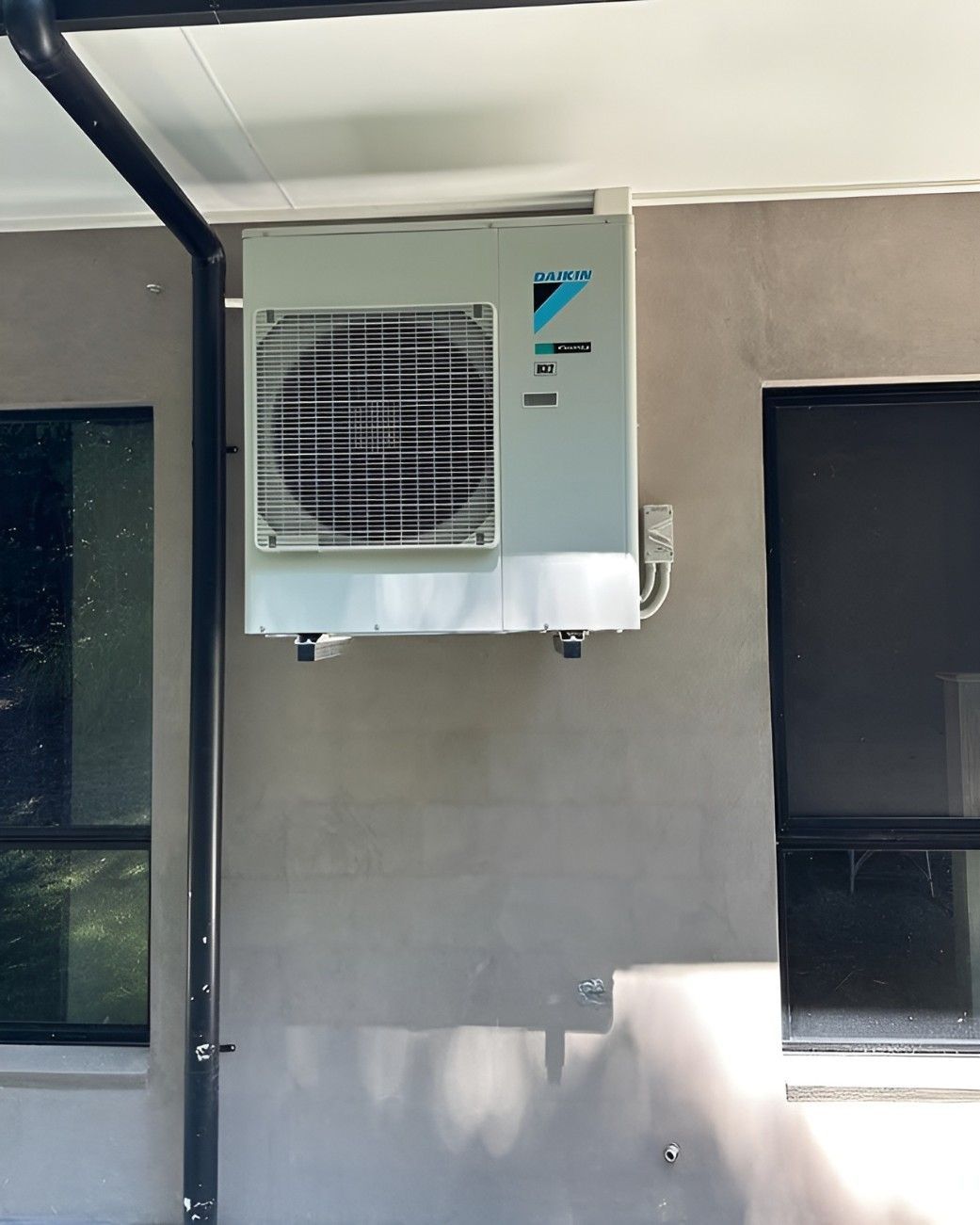 A Daikin Air Conditioner is Mounted on the Side of a Building — Eclipse Air Conditioning and Refrigeration In Redlynch, QLD
