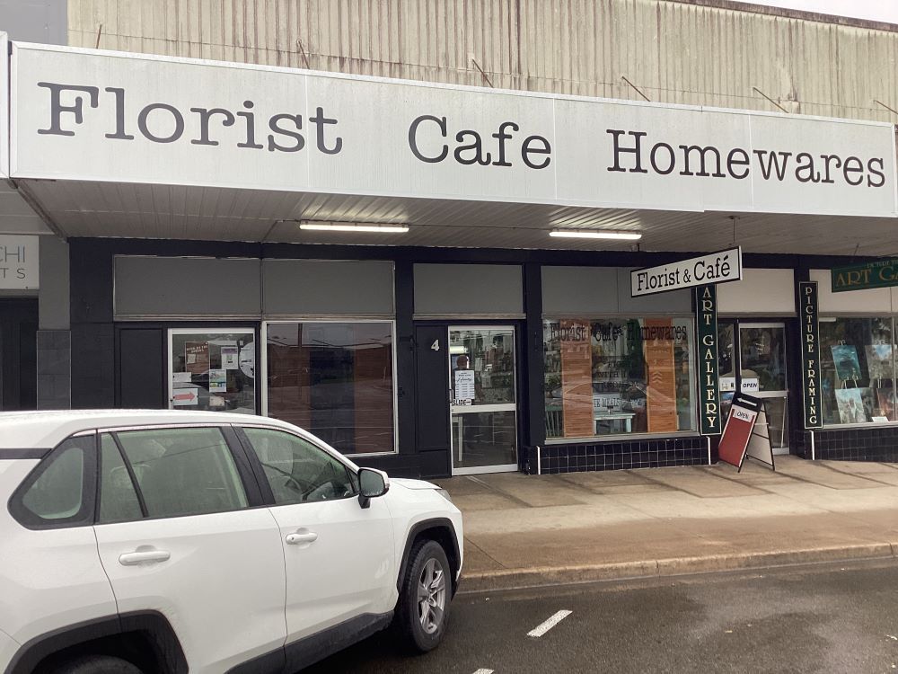 A White Car Is Parked in Front of A Building — Fiori With Love in Ingham, QLD