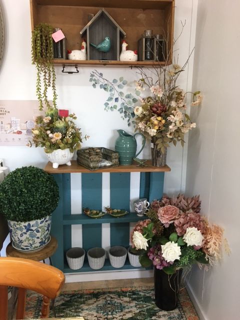 A Room with A Shelf Filled with Potted Plants and Flowers — Fiori With Love in Ingham, QLD