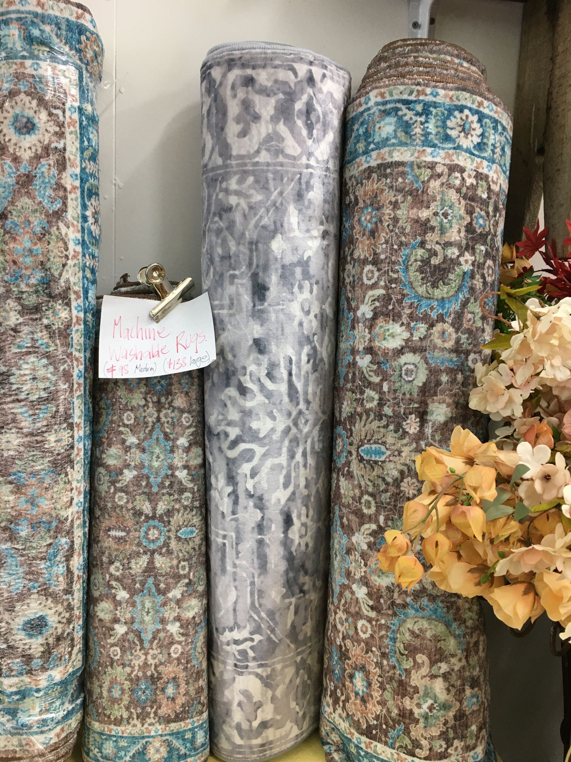 A Bunch of Rugs Are Stacked on Top of Each Other on A Shelf — Fiori With Love in Ingham, QLD