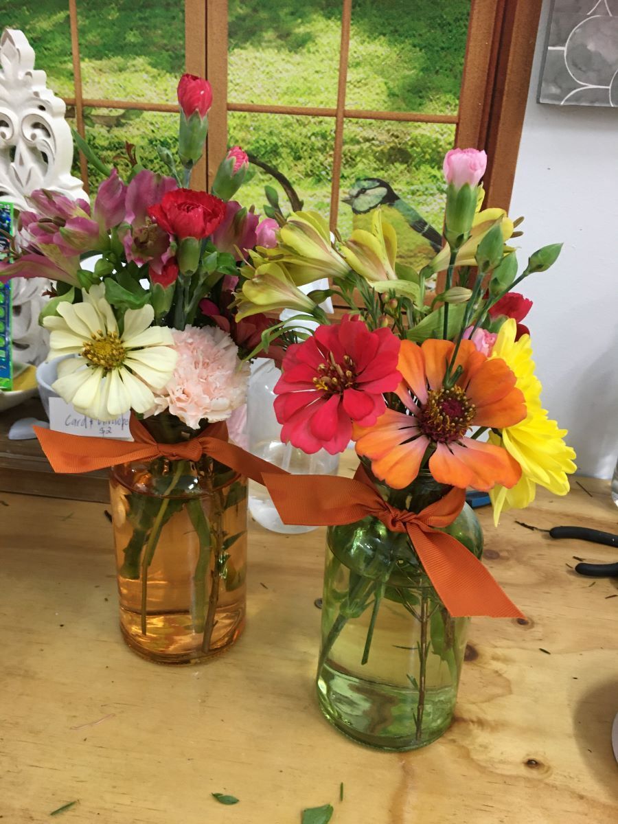 Two Vases Filled with Flowers Are on A Table — Fiori With Love in Cardwell, QLD