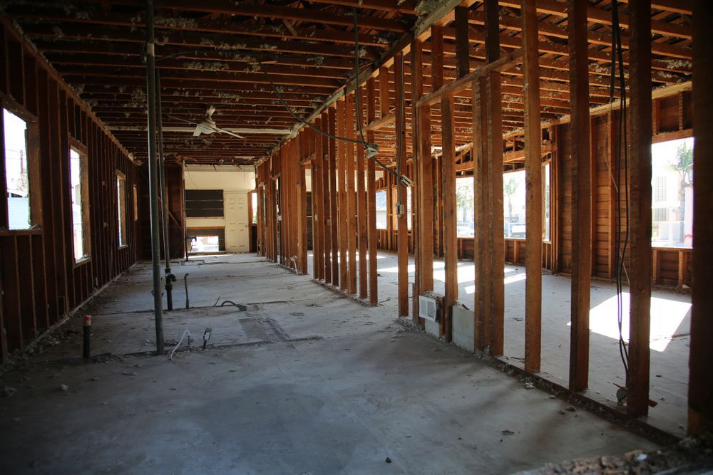 an empty room with a lot of wooden beams and windows