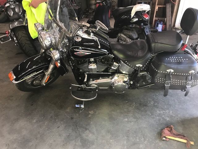 A black harley davidson motorcycle is parked in a garage.