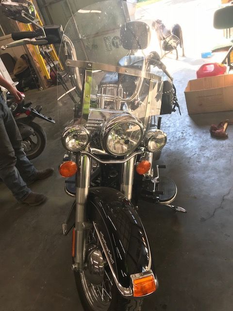 A black motorcycle is parked in a garage