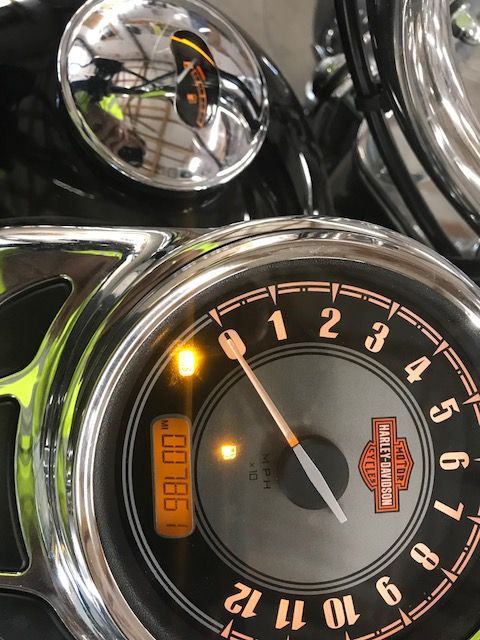A close up of a harley davidson speedometer
