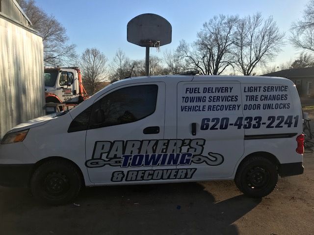 A white van that says parker 's towing and recovery