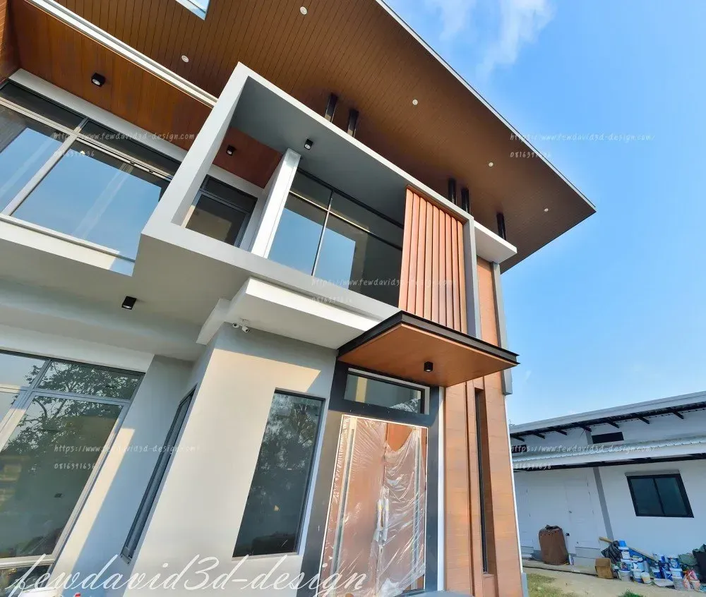 บ้านโมเดิร์นสองชั้น ดีไซน์ล้ำสมัย หลังคาเพิงหมาแหงน โดดเด่นด้วยระแนงไม้แนวตั้งและกระจกบานใหญ่ เพิ่มความโปร่งโล่งและรับแสงธรรมชาติ โทนสีขาว-เทาตัดกับงานไม้ ให้ความหรูหราและอบอุ่น เหมาะสำหรับผู้ที่มองหาบ้านสไตล์โมเดิร์นทันสมัย รับออกแบบบ้านโมเดิร์นโดยทีมงานมืออาชีพ
