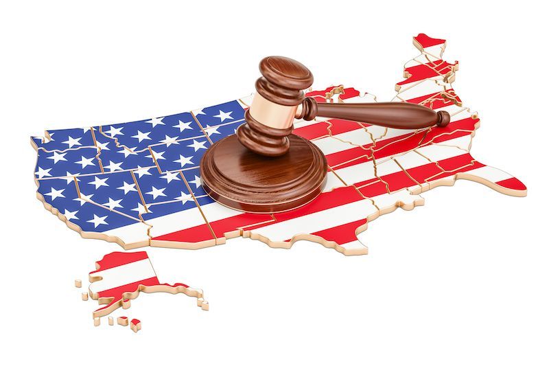 United states outlined with flag overlay and gavel on top