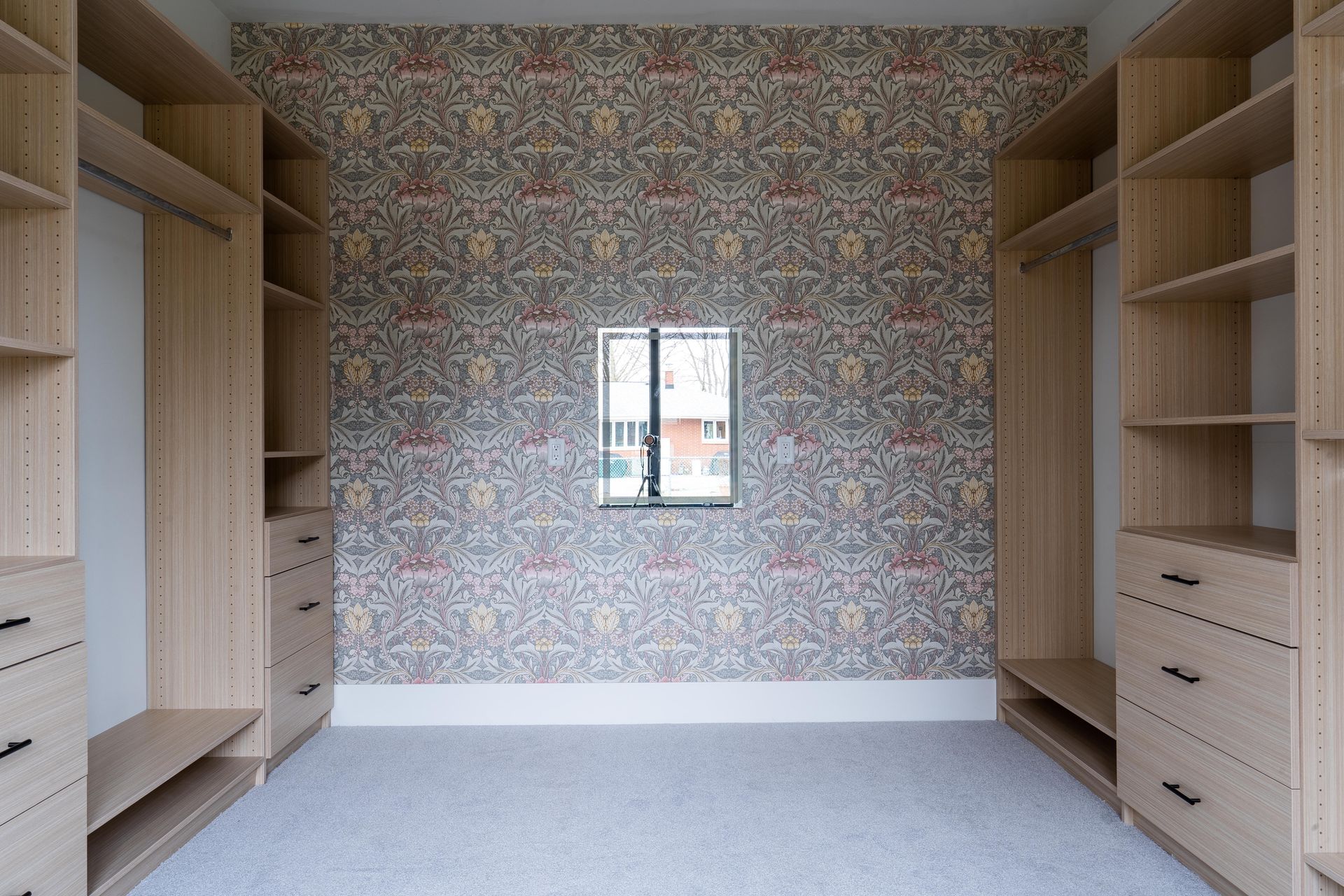 Custom walk-in closet with high end wallpaper.