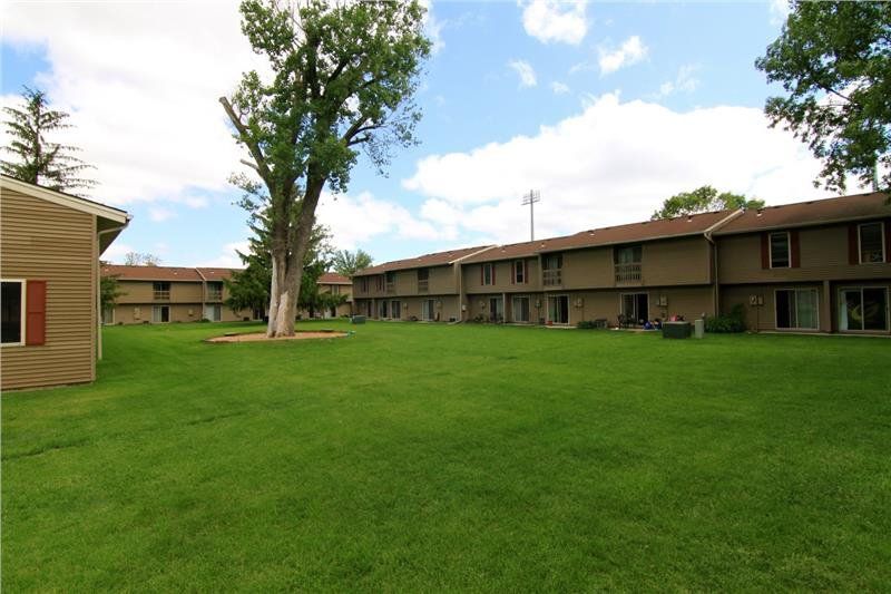 The grassy large lawn area at the Rustic Woods townhomes