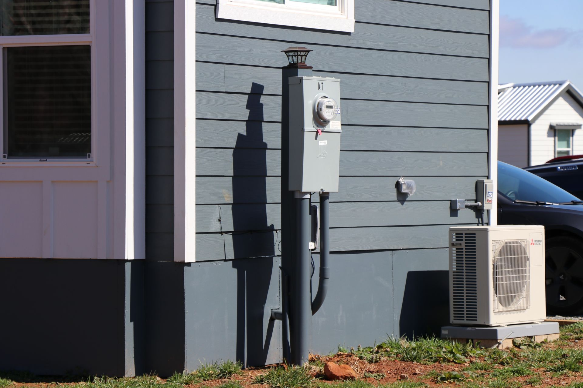Gray roadside camera box mounted on a wooden pole outdoors